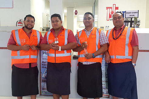 Samoa Post operational team holding Samoa's awards for SPS delivery performance